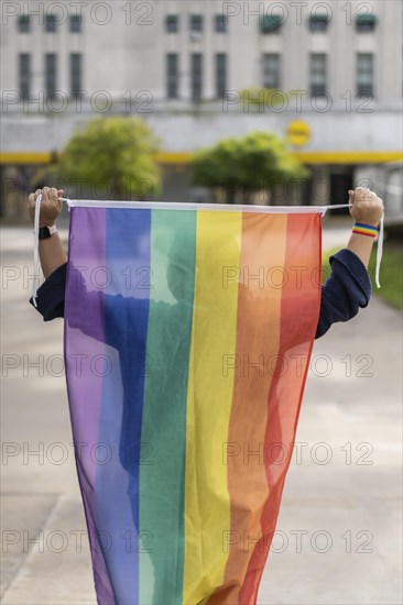 Woman from the back holding lgbt flag