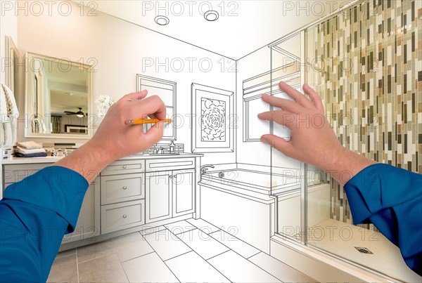 Male hands sketching beautiful custom bathroom gradating to finished construction