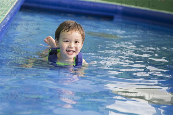 Adorable mixed-race boy having fun at the water park