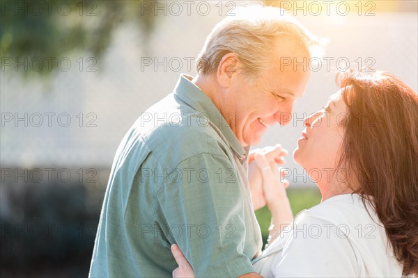 Happy middle aged couple enjoy A romantic slow dance outside
