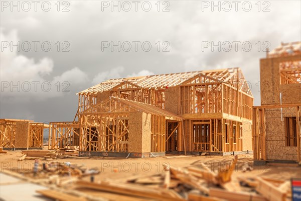 Wood home framing abstract at construction site with stormy clouds behind