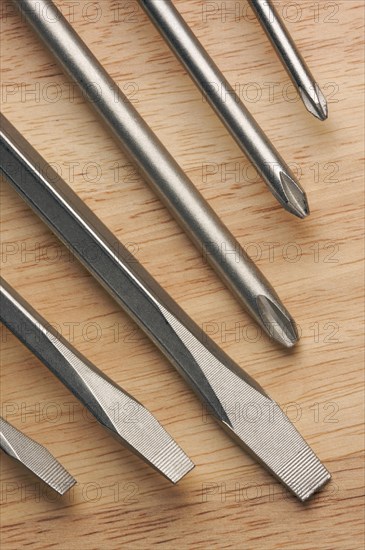 Series of screwdrivers on a wood background