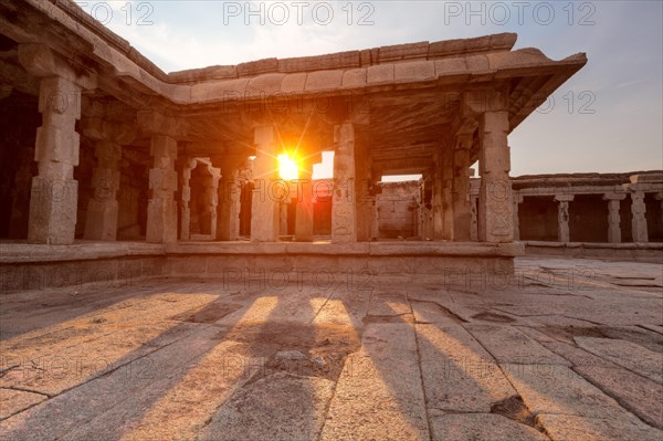 Pillared porch in Krishna Temple on sunset. Hampi