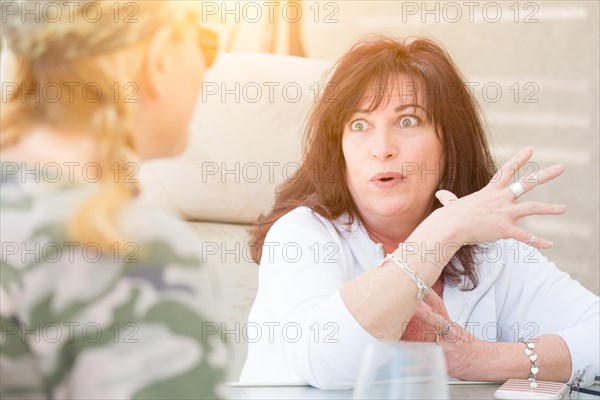 Two female friends enjoying conversation on the patio