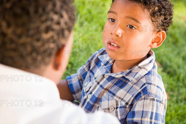 Happy african american father and mixed-race son playing at the park