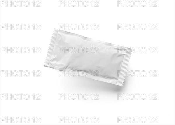 Blank white condiment packet floating isolated on white background