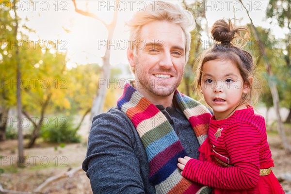 Handsome caucasian young man with mixed-race baby girl outdoors