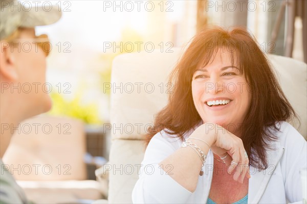 Two female friends enjoying conversation on the patio