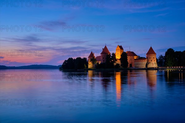 Night view of Trakai Island Castle in lake Galve illuminated in the evening