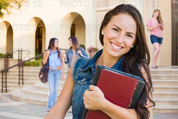 mixed-race young girl student with school books on campus