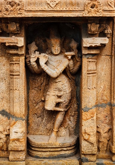 Krishna playing flute bas relief in Hindu temple