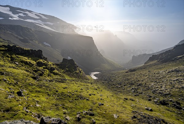 View into canyon with moss and black volcanic stone at Heljarkambur