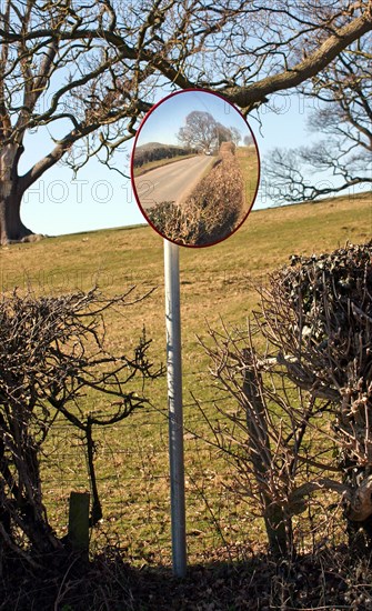 Using a convex mirror to see road traffic from the farm entrance