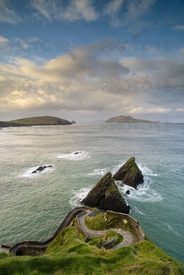 View of winding coastal pathway to pier at dawn