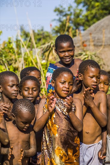 Children watch with interest at traditional customs in real African village