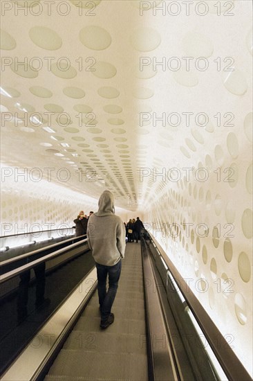 Young man on escalator