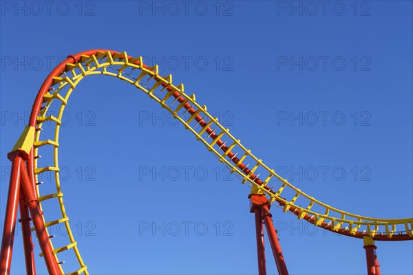 Roller coaster in front of blue sky