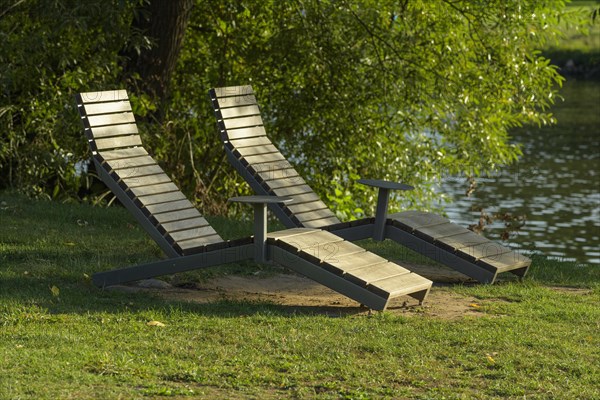Wooden loungers on the river bank