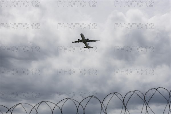 Aircraft taking off against a dark cloudy sky