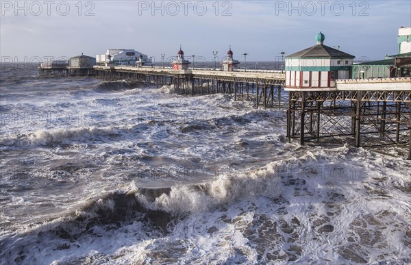 Stormy seas and Victorian pier at the seaside resort