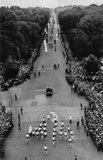 The relay with the Olympic flame on the way to the stadium