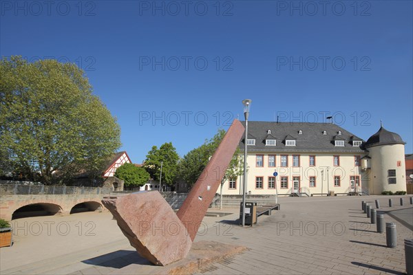 Winery building with witch tower built in 1719 and modern sculpture at the Kellereiplatz in Hofheim