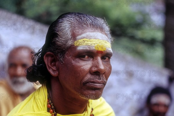 A Sadhu sitting on the steps of Arulmigu Dhandayuthapani Swamy Temple at Palani near Coimbatore