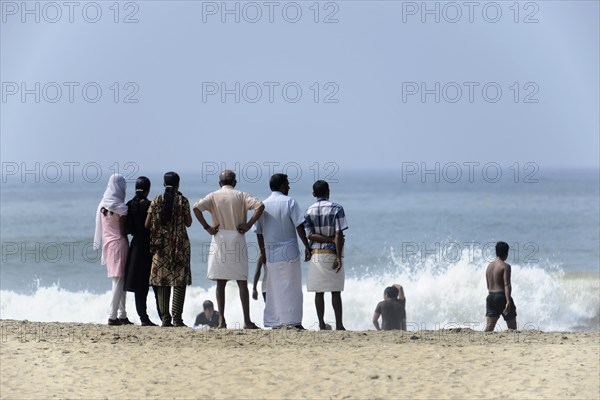 Holidaymakers on the beach of Kovalam