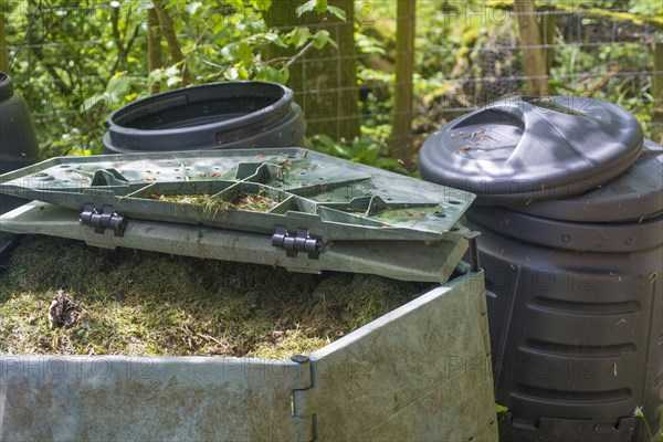 Mowing grass in garden compost bins