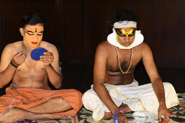 Kathakali dancer putting on make-up