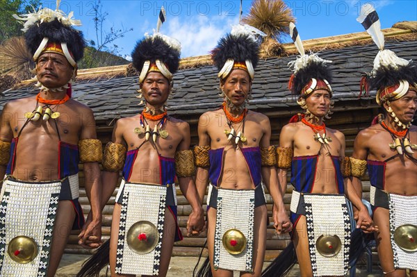 Naga tribesmen in traditional dress perform ritual dances