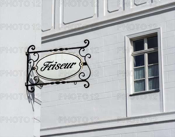 Old ceramic sign on a barbershop