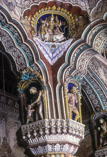 Siva and Parvathi seated on Rishaba or bull. 18th century stucco works and fresco painted pillars of Maratha Darbar hall inside Thanjavur palace complex