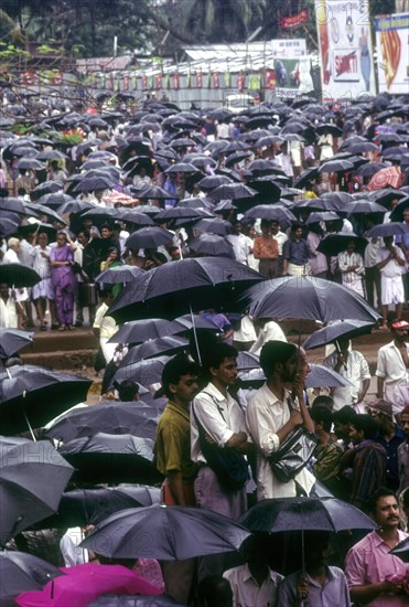 Crowd with umbrellas in raining during Pooram festival in Thrissur or Trichur