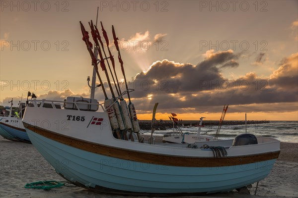 Fishing boats in the evening light at the natural harbour of Vorupoer