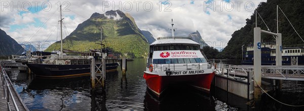 Excursion boats anchor in the fjord landscape at Milford Sound