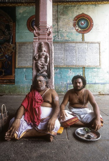 Priest sitting in the corridor of the Vaitheeswaran Temple