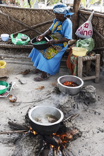 Woman cooking over an open fire