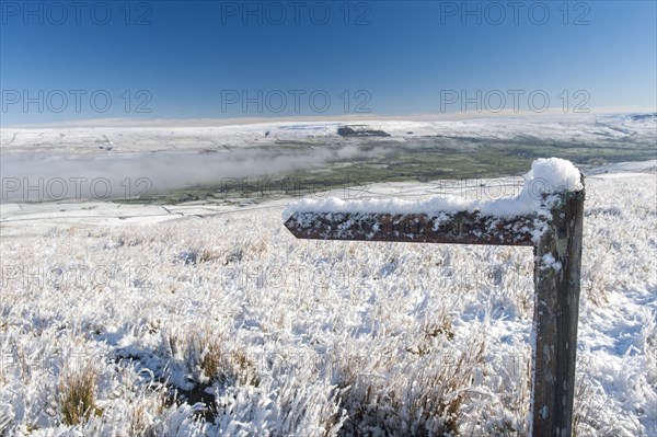 Snow covered footpath sign in Wensleydale