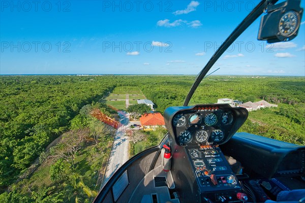 View from cockpit of helicopter type Bell 206B Jet Ranger III on approach