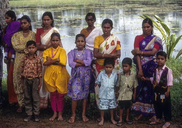 Spectators during boat race standing under the tree shades in the River bank at Payipad near Haripad