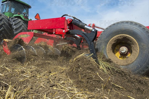 John Deere 9400 pulling Vaderstad TopDown 700 cultivator and tilling stubble field