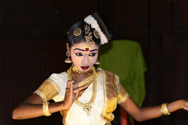 Fully made up and costumed Kathakali dancer performing