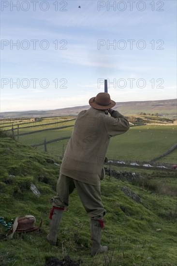 Man with a 12-gauge shotgun