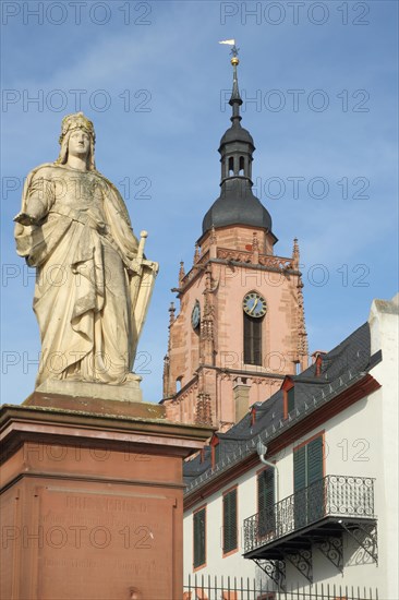 Germania figure on the square of Montrichard with tower of St. Peter and Paul Church in Eltville