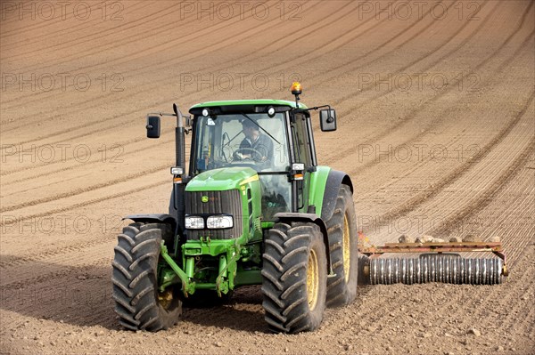 John Deere tractor pulling the soil press