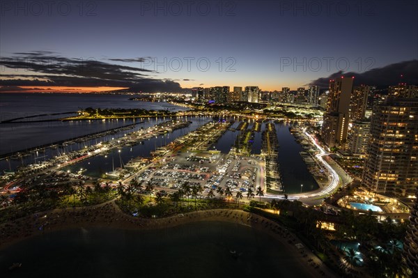 Dusk at the Ala Wai boat harbour with a view over Waikiki to Honolulu