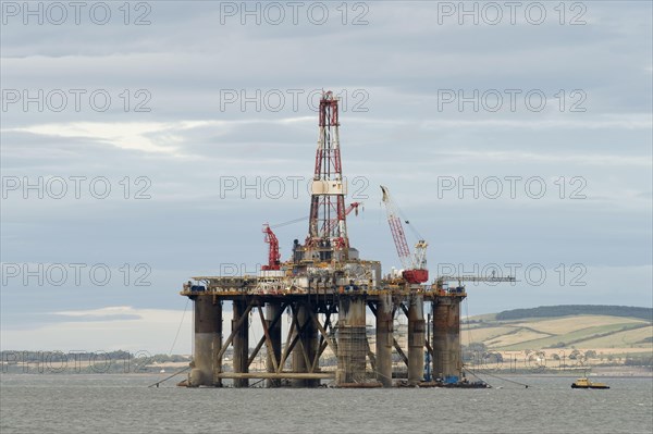 Oil rig moored in sea near coast