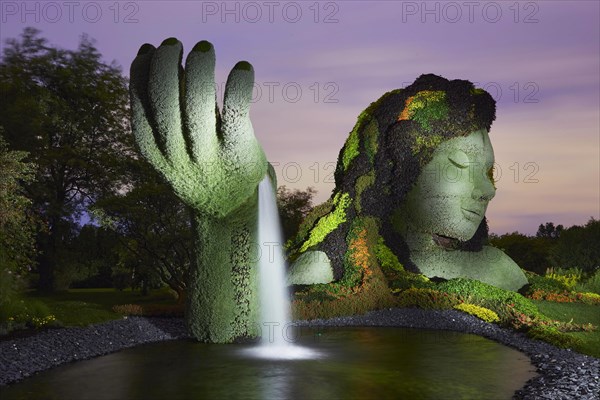 Light painting photography of a garden sculpture