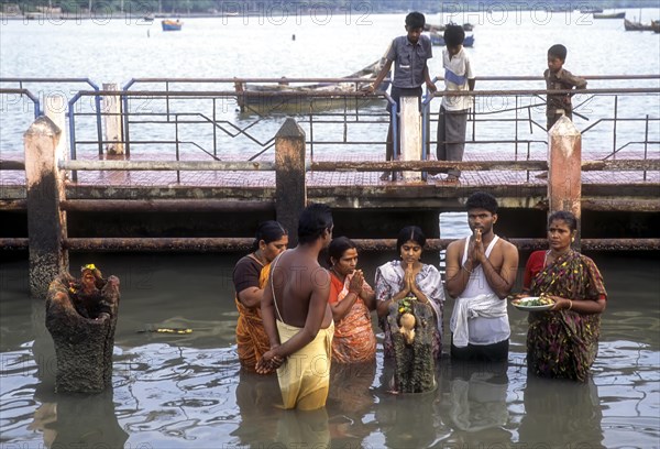 A group of people worshipping Navagraha idols